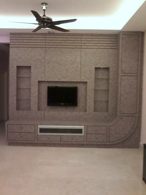 Completed textured feature wall with TV recess, display niches and low cabinet
